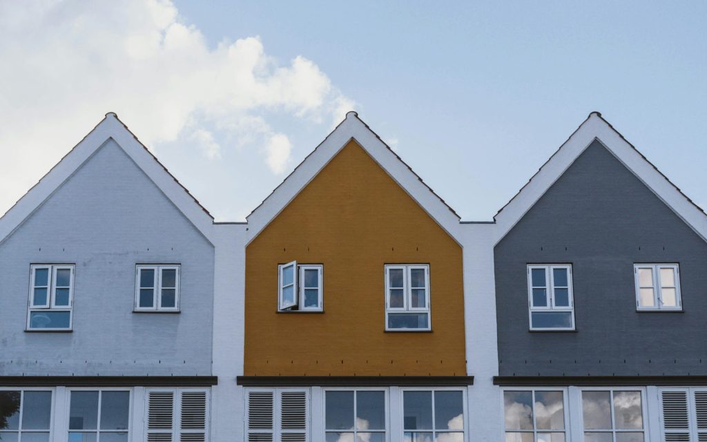white and brown concrete house under blue sky during daytime